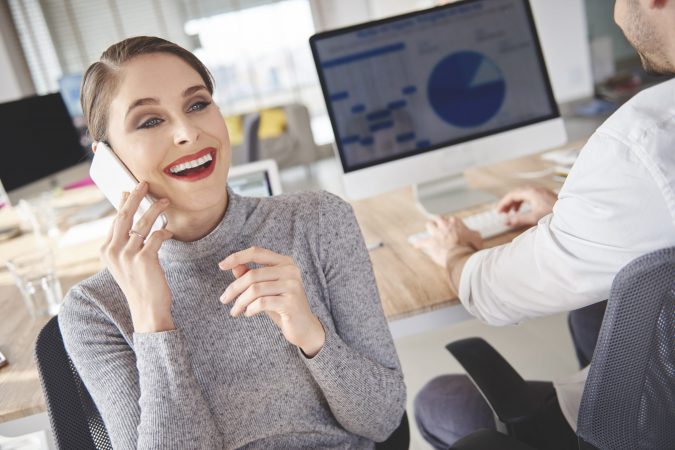 Woman booking meetings with customers by the phone
